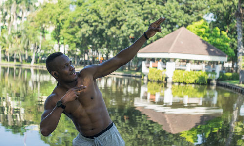 Man standing by swimming pool