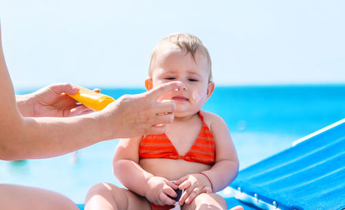 Portrait of cute boy playing in swimming pool