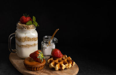 High angle view of breakfast on table against black background