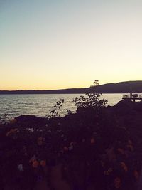 Scenic view of sea against clear sky during sunset