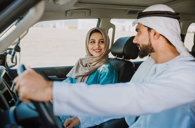 Smiling couple sitting in car