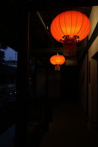 Low angle view of illuminated lantern hanging at night