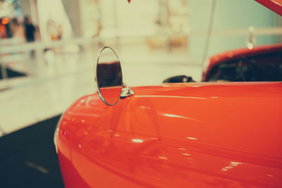 Close-up of mirror on red car