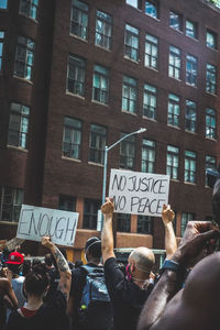 People on street against buildings in city