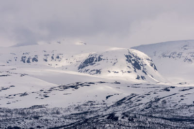 Aerial view of snowcapped mountains against sky