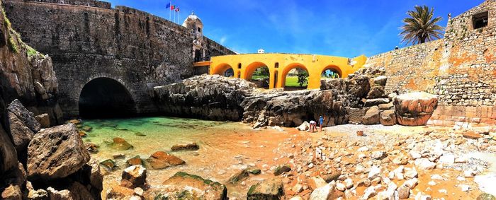 Low angle view of stone bridge against sky