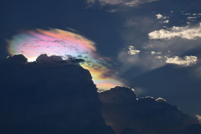 Low angle view of rainbow against sky during sunset