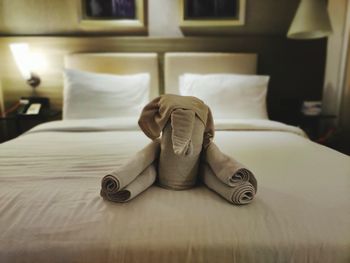Towels arranged on bed in hotel