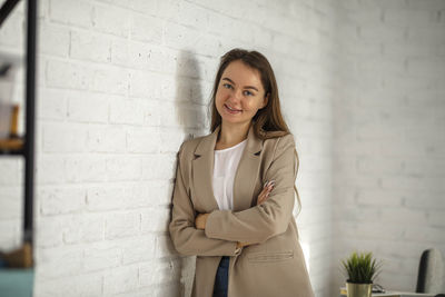 Businesswoman in office. stylish manager smiling white brick wall, work on financial project