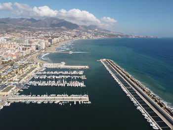 High angle view of buildings by sea against sky