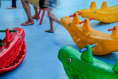 Low section of boy with toy in swimming pool