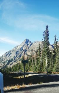 Road by mountains against blue sky