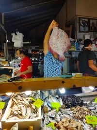 People working at market stall