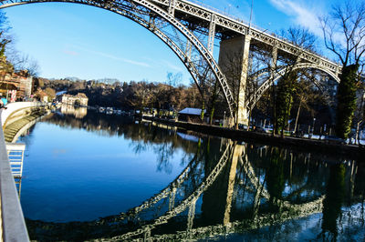 View of bridge over canal against blue sky