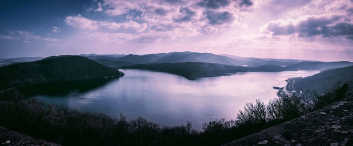 Scenic view of lake and mountains against sky