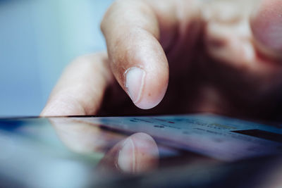 Close-up of man holding mobile phone