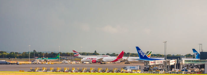 Airplane on airport runway against sky