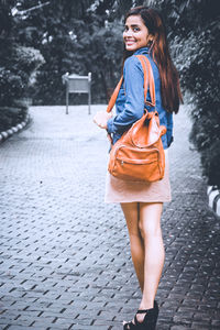 Portrait of a smiling young woman standing outdoors