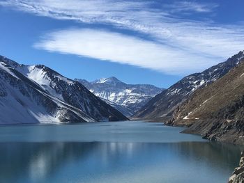 Scenic view of lake and mountains against blue sky