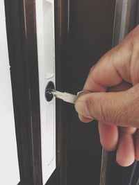 Close-up of hand holding cigarette