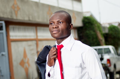 Young man standing against wall