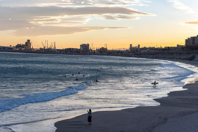 Scenic view of beach against sky during sunset