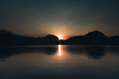 Scenic view of lake against sky during sunset