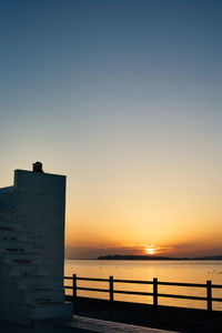 Scenic view of sea against clear sky during sunset