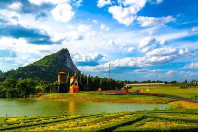 Scenic view of grassy field against cloudy sky