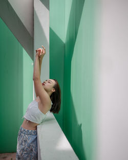 Woman standing against wall