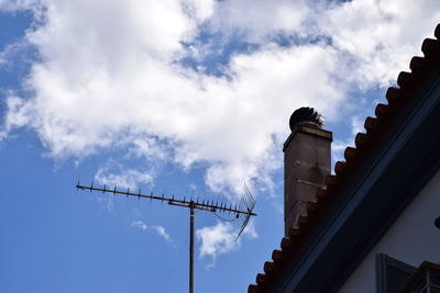 Low angle view of building against cloudy sky