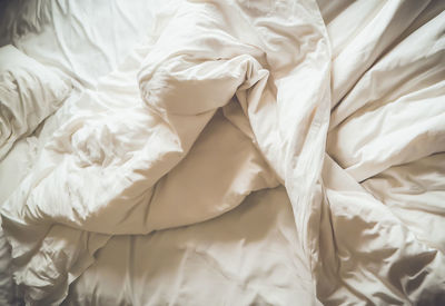 High angle view of messy bed