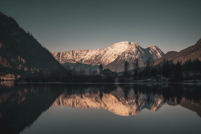 Scenic view of lake and mountains against sky during winter