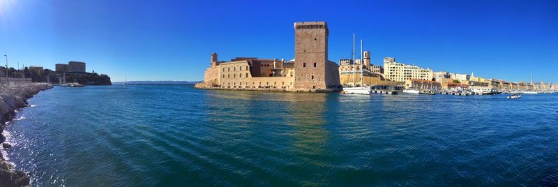 Panoramic view of fort saint-jean by sea against blue sky
