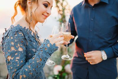 Midsection of woman drinking glass