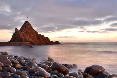 Scenic view of sea against sky at sunset