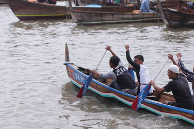 People on boat sailing in river