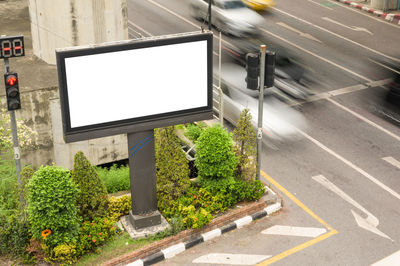 Road sign by street in city