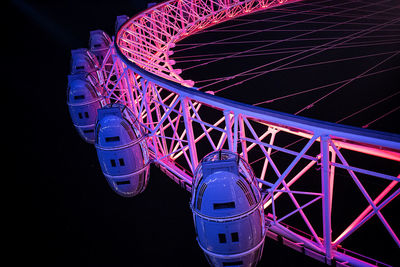 Illuminated ferris wheel at night