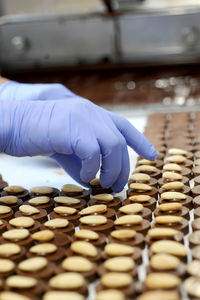 The worker puts almonds on chocolates at the chocolate factory