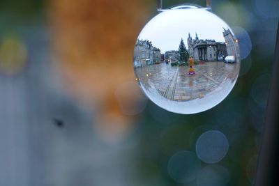 Close-up of crystal ball with reflection of water