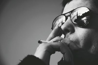 Close-up of young man smoking cigarette