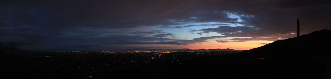 Silhouette cityscape against sky during sunset