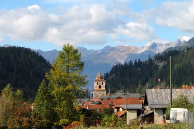 Panoramic view of trees and buildings against sky