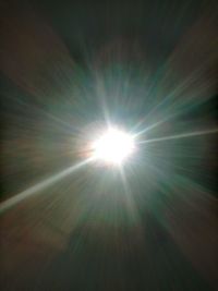 Low angle view of sun shining in sky