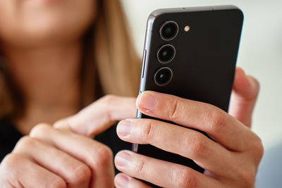 Midsection of woman using mobile phone