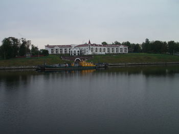 Arch bridge over river against buildings