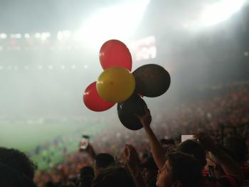 Group of people with balloons in background