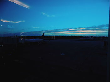 Silhouette of airplane against sky at night