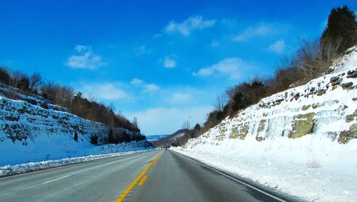 Road passing through snow covered landscape